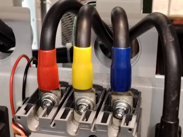 Close up image of three phase cable connection breaker in low voltage electrical board.